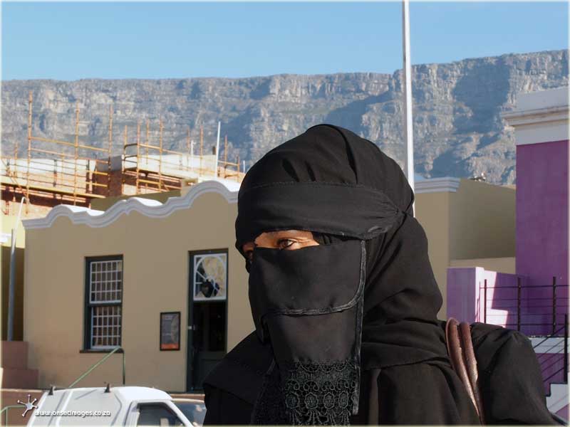 Burka dresses Tourist Guide Aqeelah Hendricks of Aqeelah Tours (Khanizeni) in front of the Bo-Kaap Iziko Museum with Table Mountain as backdrop